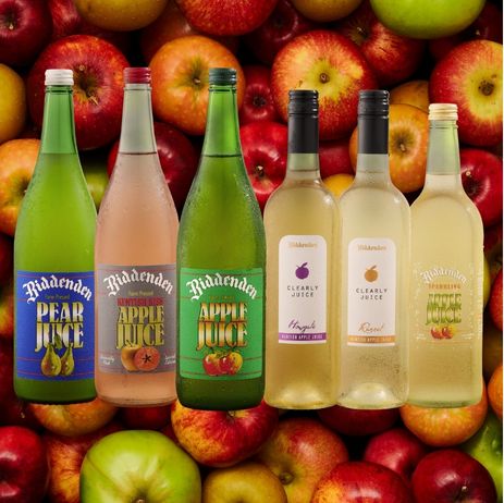 Biddenden juice bottles displayed among a variety of apples.