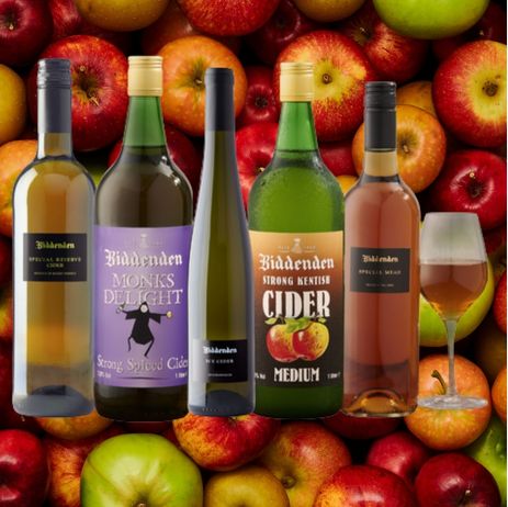 Biddenden cider bottles with a glass of cider against a background of apples